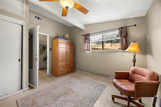 sitting room featuring beam ceiling, visible vents, and ceiling fan