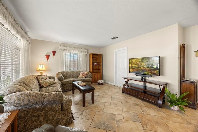 living area featuring visible vents and baseboards