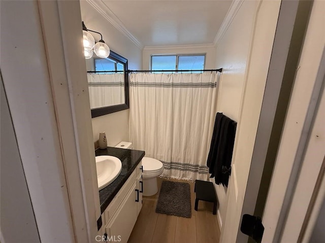 bathroom with curtained shower, crown molding, toilet, wood finished floors, and vanity