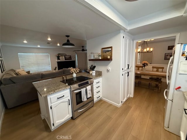 kitchen featuring stainless steel electric range oven, light wood-type flooring, a peninsula, freestanding refrigerator, and white cabinets