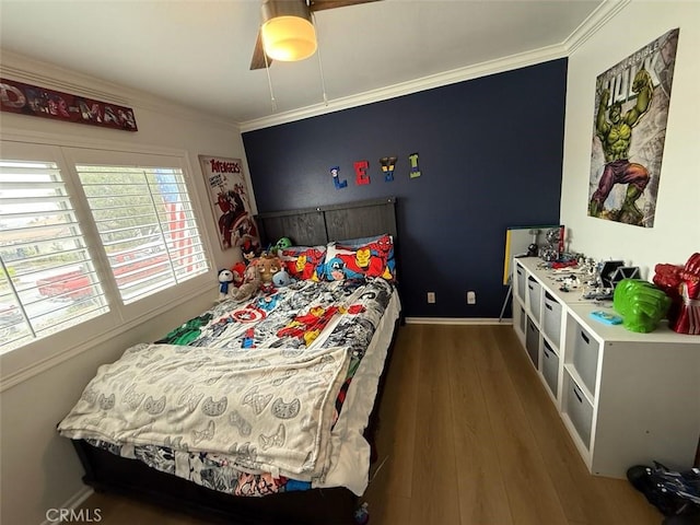 bedroom featuring wood finished floors, a ceiling fan, baseboards, and ornamental molding