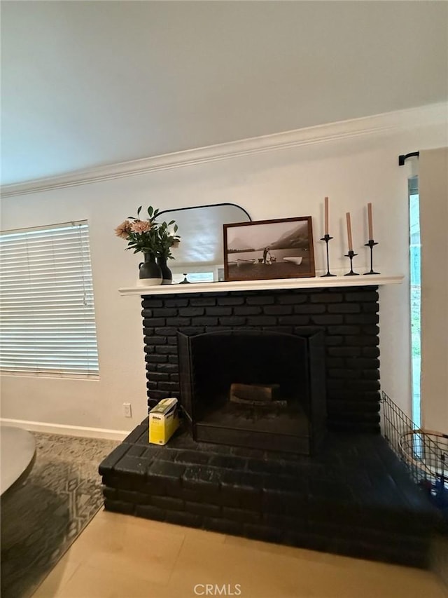 details with a fireplace, crown molding, and baseboards