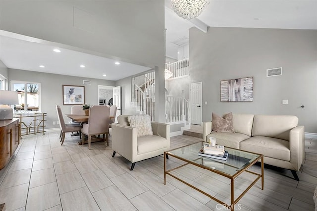 living area featuring stairway, baseboards, and visible vents