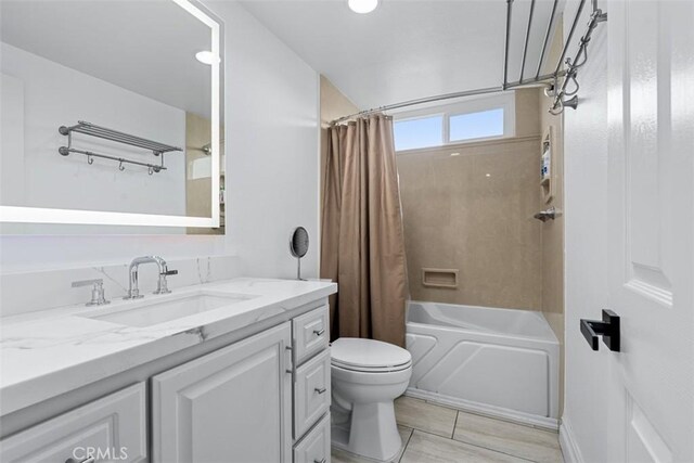 bathroom featuring vanity, toilet, and shower / tub combo with curtain