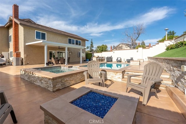 view of swimming pool with a patio area, a fenced backyard, central AC, and an outdoor fire pit