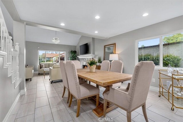 dining area featuring recessed lighting, baseboards, and vaulted ceiling