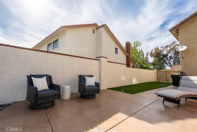 view of patio / terrace featuring a gate and fence