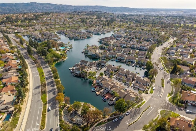 drone / aerial view with a residential view and a water view