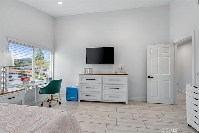 bedroom with wood finish floors, baseboards, a towering ceiling, and recessed lighting