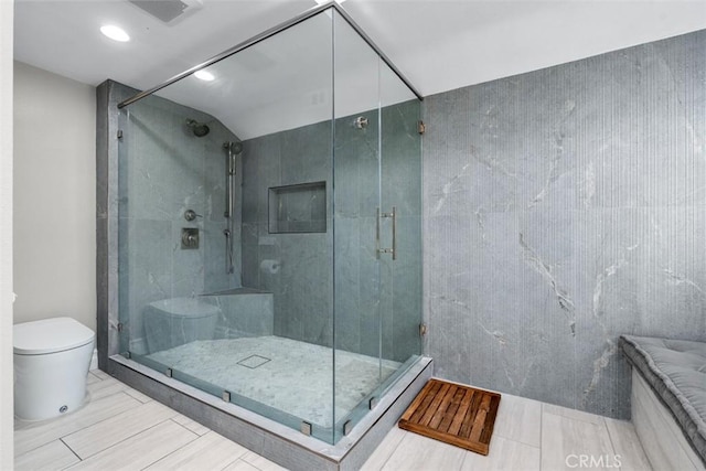 full bathroom with visible vents, a shower stall, and toilet