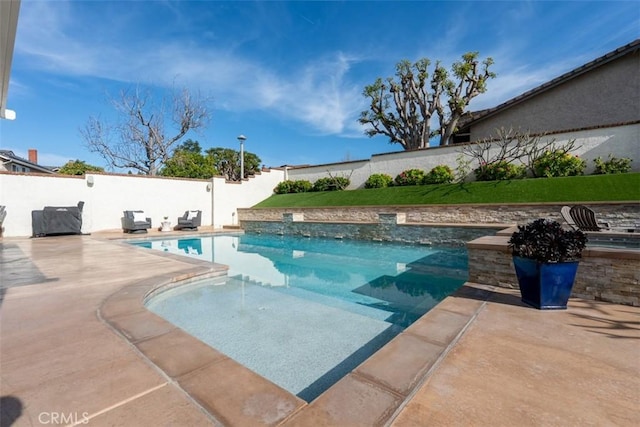 view of swimming pool with a patio area, a fenced in pool, and a fenced backyard