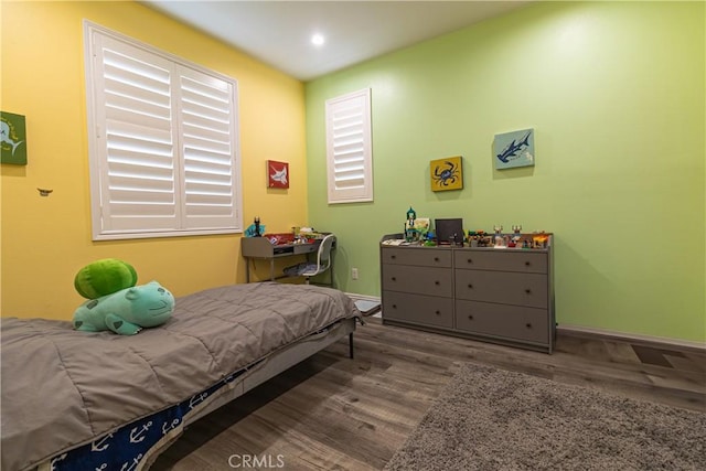 bedroom with recessed lighting, baseboards, and wood finished floors