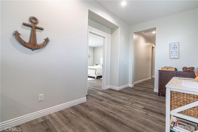 hall with baseboards and dark wood-style floors