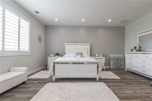 bedroom with recessed lighting, wood finished floors, visible vents, and baseboards