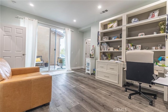 office space featuring recessed lighting, wood finished floors, visible vents, and baseboards