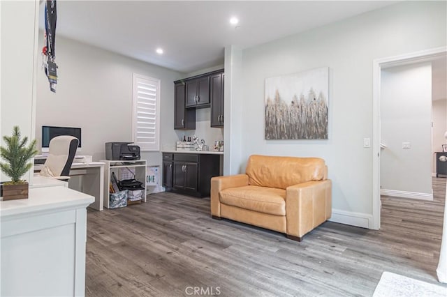 home office with recessed lighting, wood finished floors, and baseboards