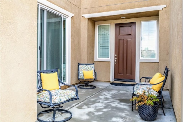 doorway to property with stucco siding