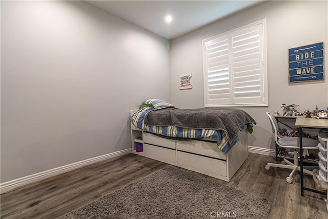 bedroom with recessed lighting, wood finished floors, and baseboards