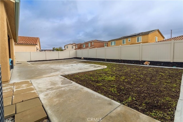 view of yard featuring a patio and a fenced backyard