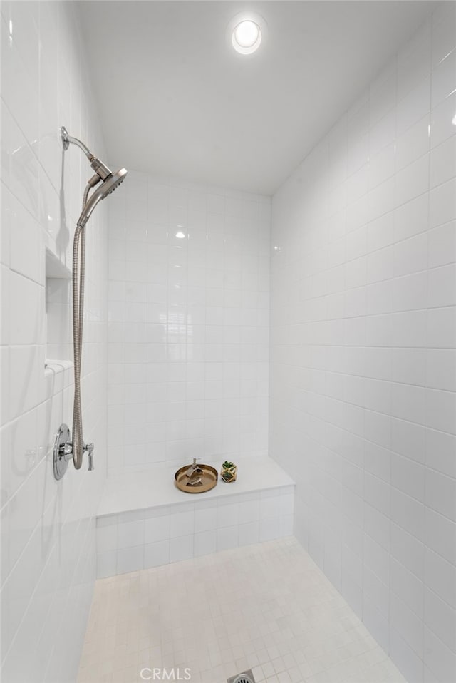 bathroom with tiled shower