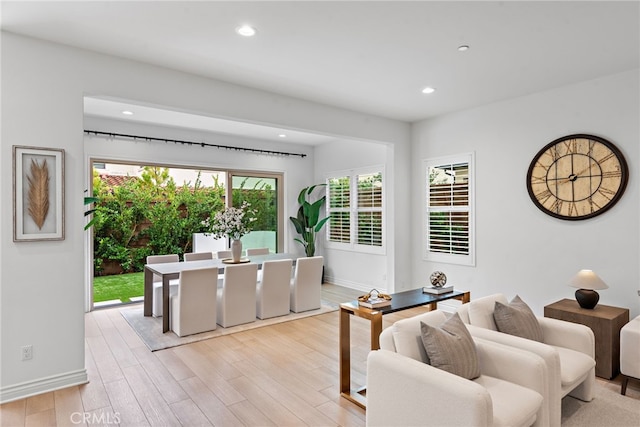 living area with recessed lighting, baseboards, and light wood finished floors