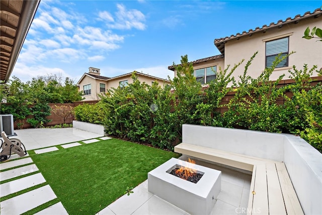 view of yard with a patio, a fire pit, and a fenced backyard