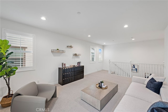 carpeted living room with recessed lighting and baseboards