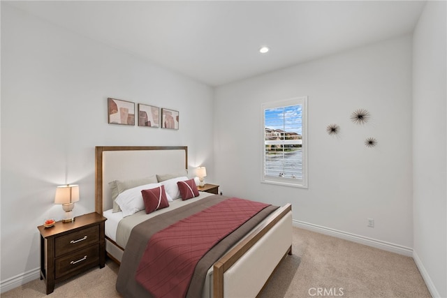 bedroom with recessed lighting, baseboards, and light carpet