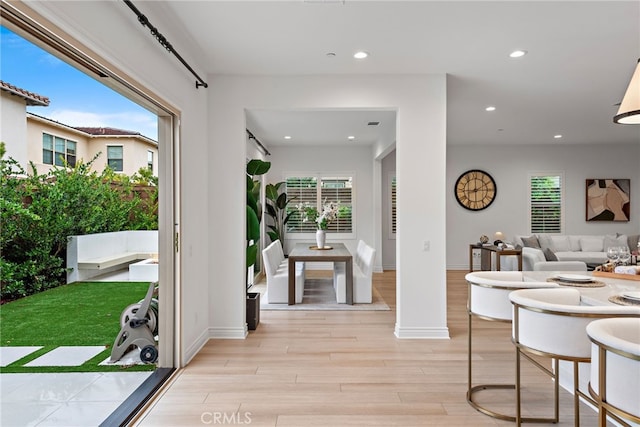 interior space featuring recessed lighting, baseboards, and light wood-style floors