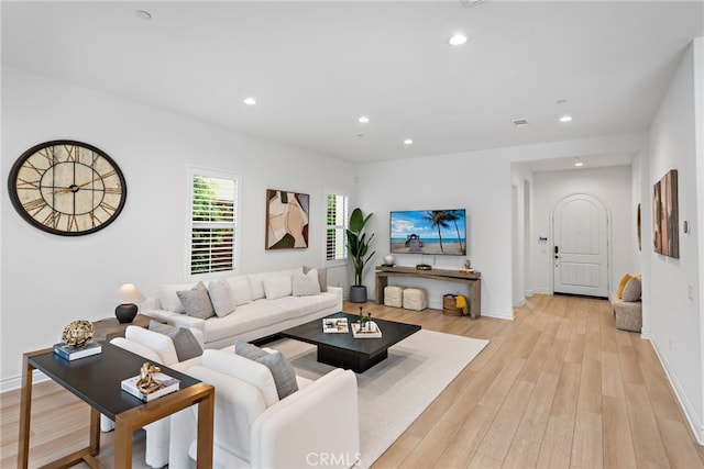 living room featuring recessed lighting, light wood-type flooring, and baseboards