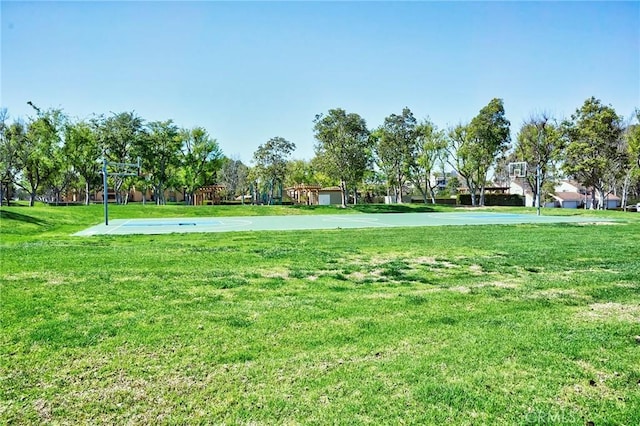 view of property's community with a yard and community basketball court