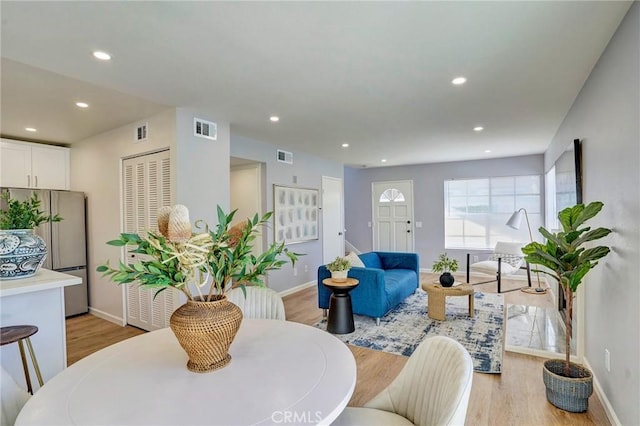 dining space featuring recessed lighting, light wood-style floors, and visible vents