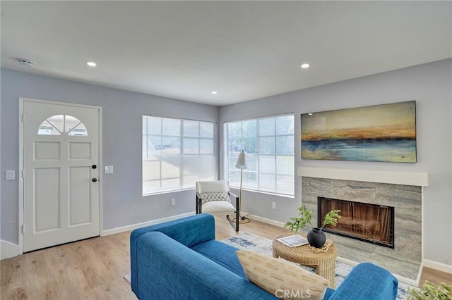 interior space featuring recessed lighting, baseboards, and light wood finished floors