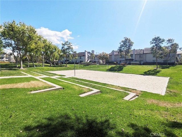 view of community featuring a lawn, volleyball court, and a residential view