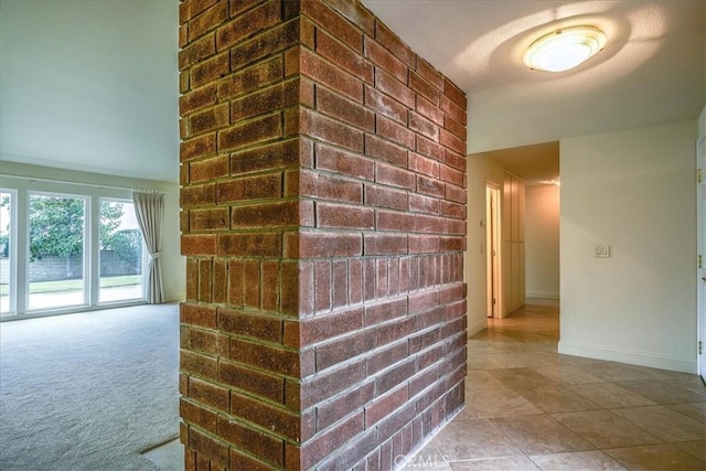 hallway featuring baseboards and carpet floors