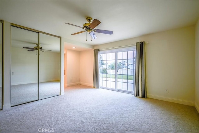 unfurnished bedroom featuring carpet flooring, a ceiling fan, baseboards, and a closet