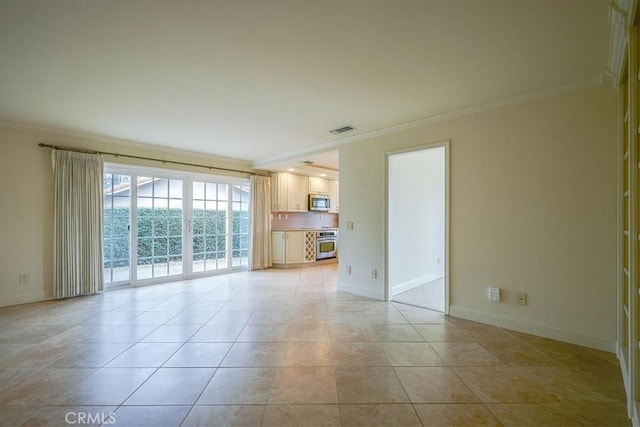 unfurnished living room featuring visible vents, baseboards, light tile patterned flooring, and crown molding