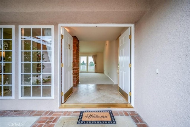 property entrance with stucco siding