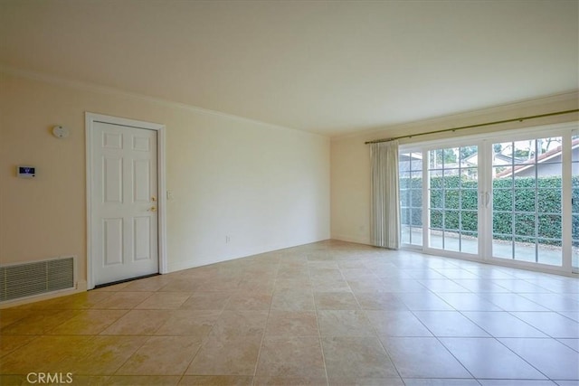 empty room featuring light tile patterned floors, visible vents, baseboards, and ornamental molding