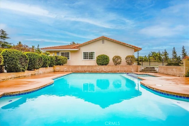 view of pool with a fenced in pool, a patio, and fence