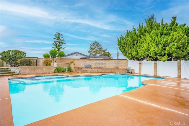 view of pool with a patio area, a fenced in pool, and fence