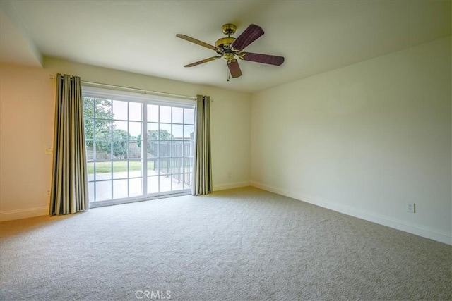 empty room featuring baseboards, a ceiling fan, and carpet flooring