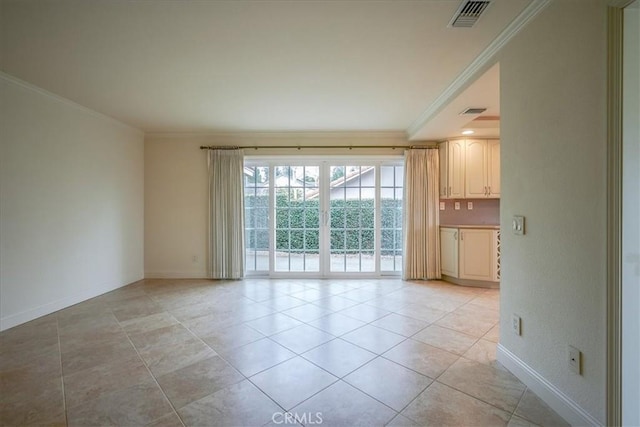 empty room featuring visible vents, baseboards, and ornamental molding