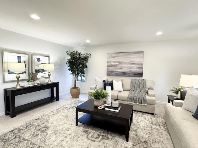 tiled living area with recessed lighting and baseboards