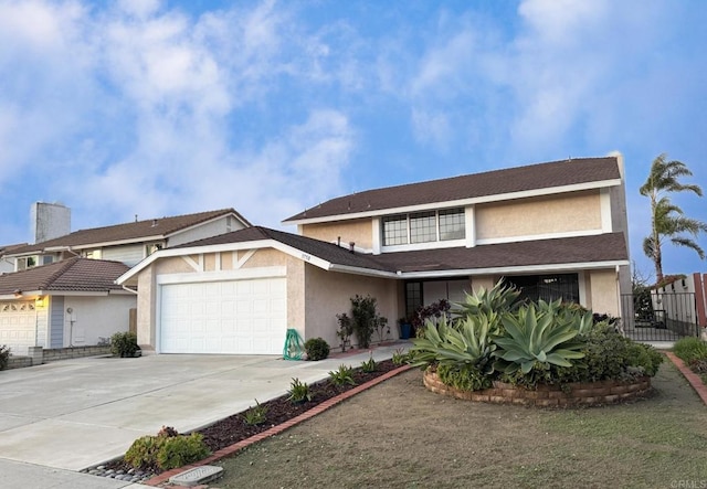 view of front facade with stucco siding, an attached garage, concrete driveway, and fence