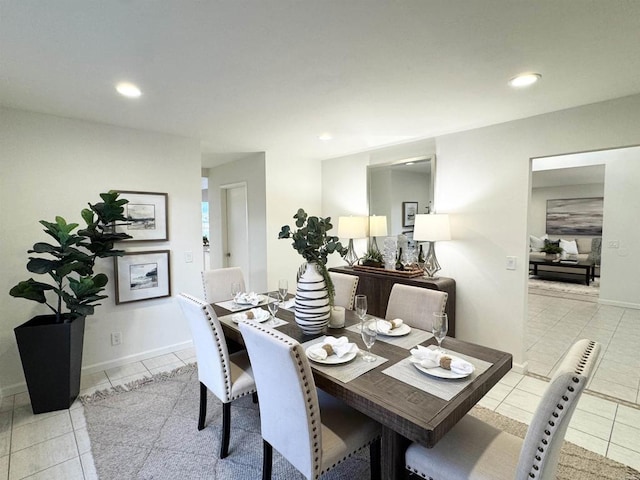 dining space featuring light tile patterned flooring, recessed lighting, and baseboards