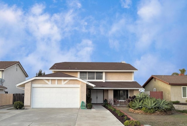 traditional-style home with stucco siding, driveway, fence, roof with shingles, and a garage