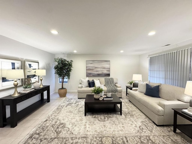 living room featuring tile patterned flooring, recessed lighting, and baseboards