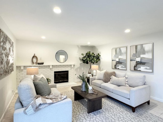 tiled living room with a brick fireplace, recessed lighting, and baseboards