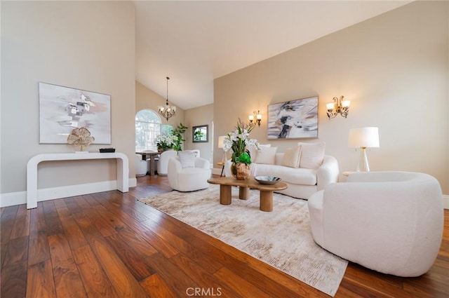 living room with baseboards, high vaulted ceiling, a chandelier, and hardwood / wood-style flooring